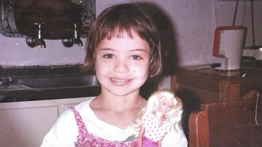Young Nicole Meyer holding a doll